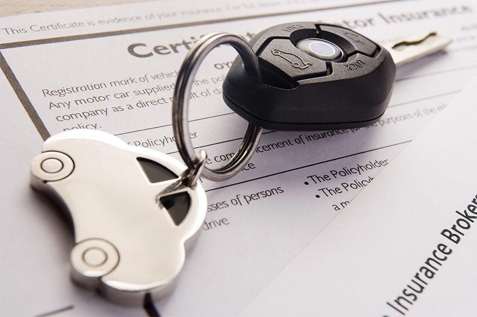 Car keys on top of Car Insurance Documents